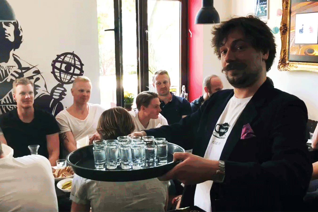 Our vodka tasting tour guide / vodka expert, Andrew, presenting a tray of shot glasses